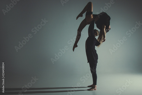 Two young modern ballet dancers in studio