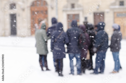 Blurred winter background big city tourists suitcases life group of people bad weather lifestyle blizzard christmas cold falls snow © mykytivoandr