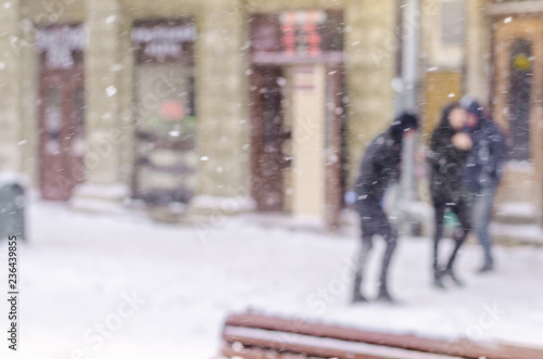 Blurred winter background big city tourists suitcases life people bad weather lifestyle blizzard christmas cold falls snow