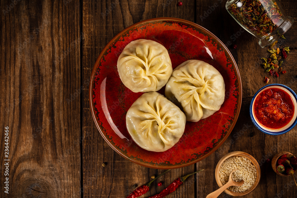 Traditional manti food on plate with sauce, top view