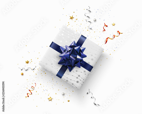 Christmas  New Year or birthday card with top view gift with blue bow and confetti.