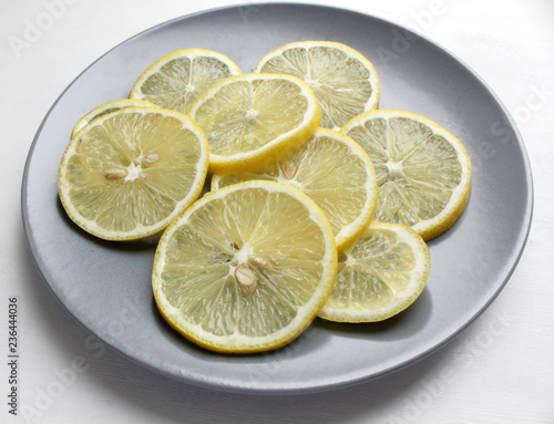 Slices of lemon on a plate on a white