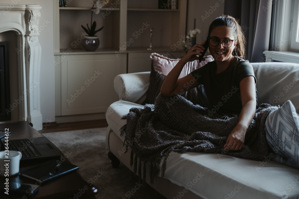 Fototapeta premium Girl smiling while talking on the phone