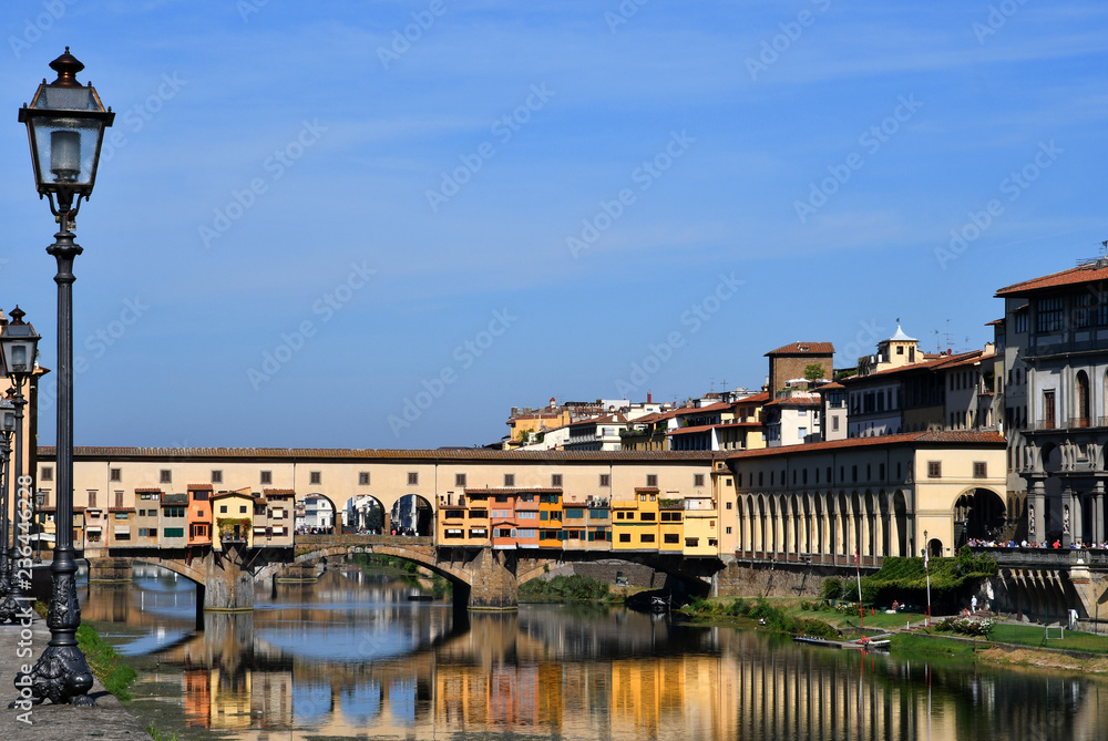 old street lamp in Florence with the famous old bridge (ponte vecchio) on background, Florence in Italy.