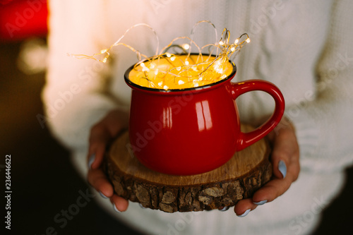A red cup and shaped bokeh above it . Coffee love concept. Сhristmas concept