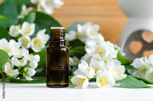 Small bottle of essential jasmine oil. Copy space.