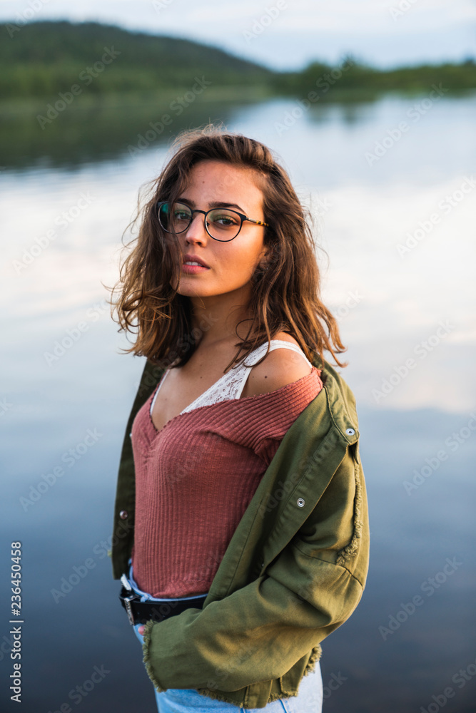 Finland, Lapland, portrait of beautiful young woman at the lakeside Finland, Lapland, portrait of beautiful young woman at the lakeside