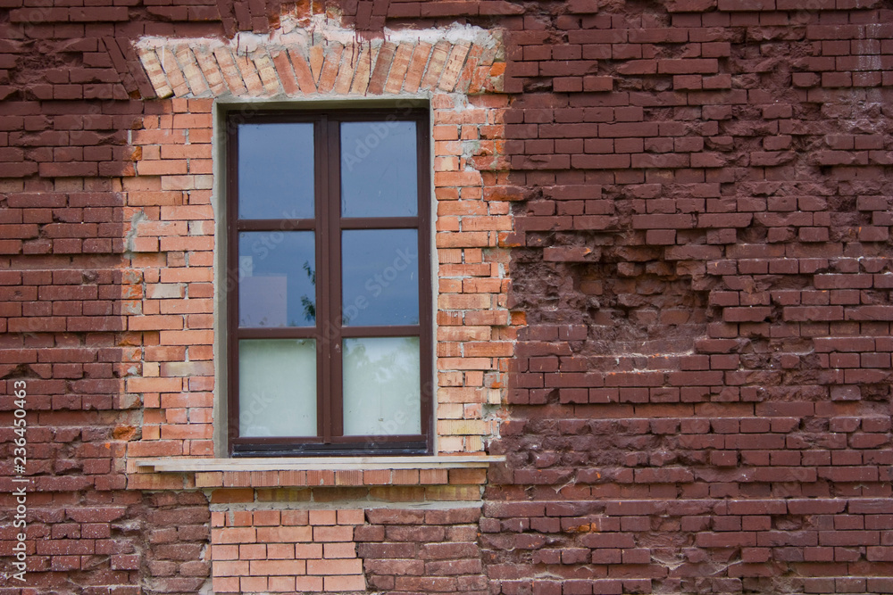 fragment of a brick wall with a window fragment of a brick wall with a window