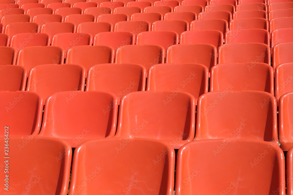 rows of orange seats for spectators of sporting events rows of orange seats for spectators of sporting events
