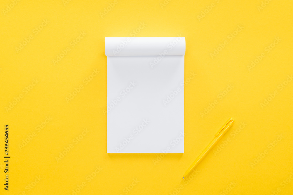 top view of blank notebook on yellow background - obrazy, fototapety, plakaty 