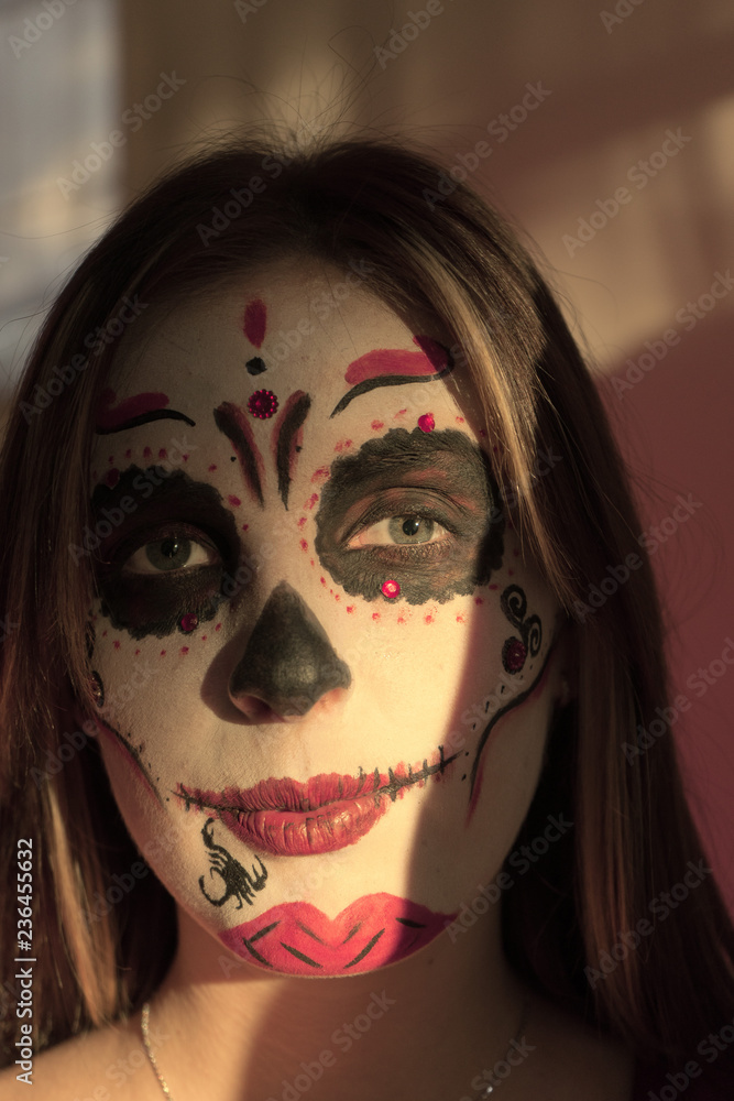 A girl with make-up skeleton on her face. Halloween. A girl with make-up skeleton on her face. Halloween.