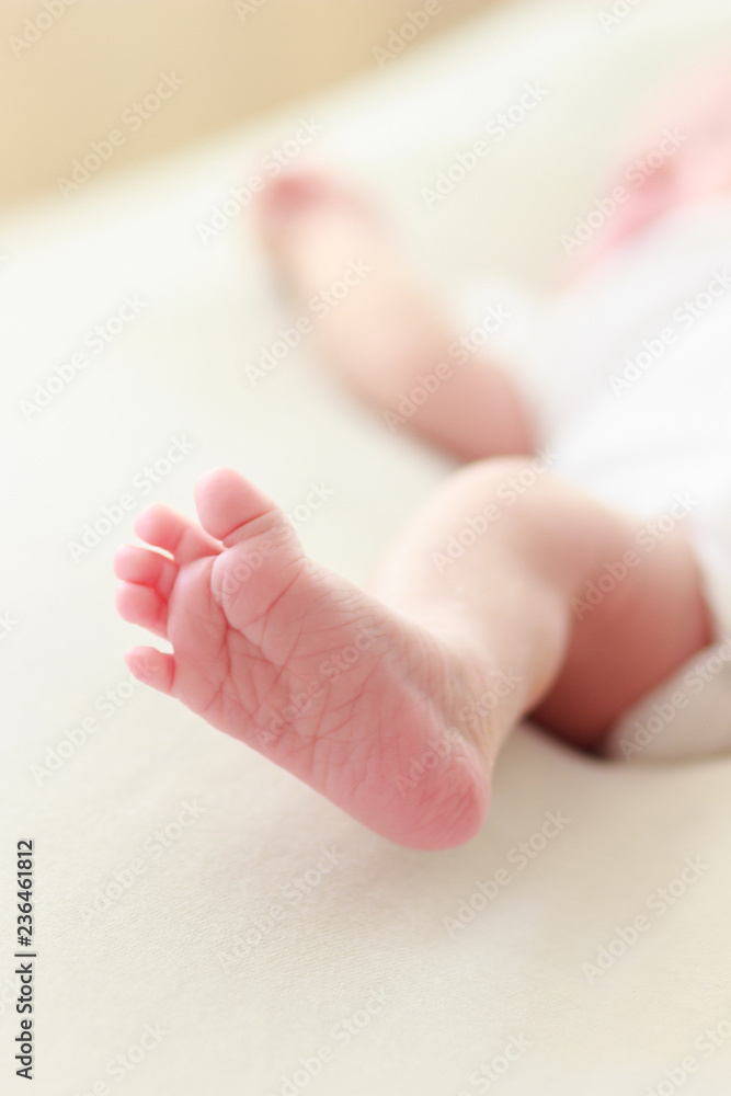 Foot of the newborn baby, soft focus background Foot of the newborn baby, soft focus background