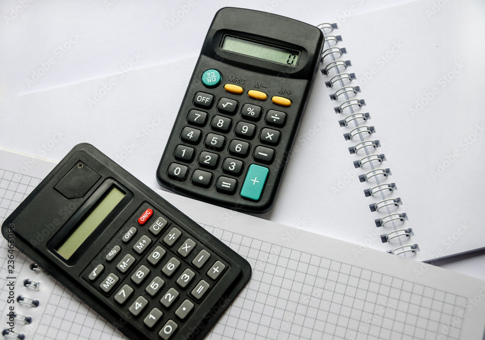 calculators and notepad on a white background calculators and notepad on a white background