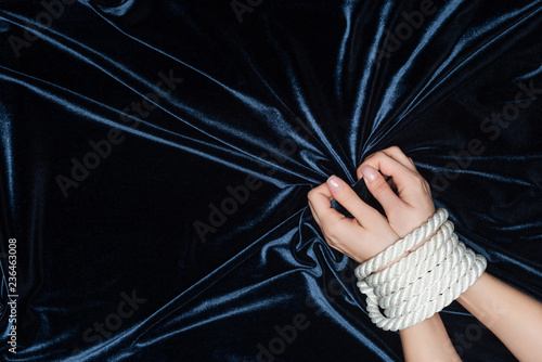 close up of female hands tightly bounded with rope