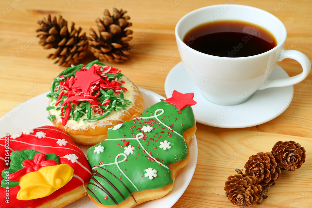 Coffee Time with Christmas Decorated Sweets Served on Wooden Table with Many Dry Pine Cones Coffee Time with Christmas Decorated Sweets Served on Wooden Table with Many Dry Pine Cones