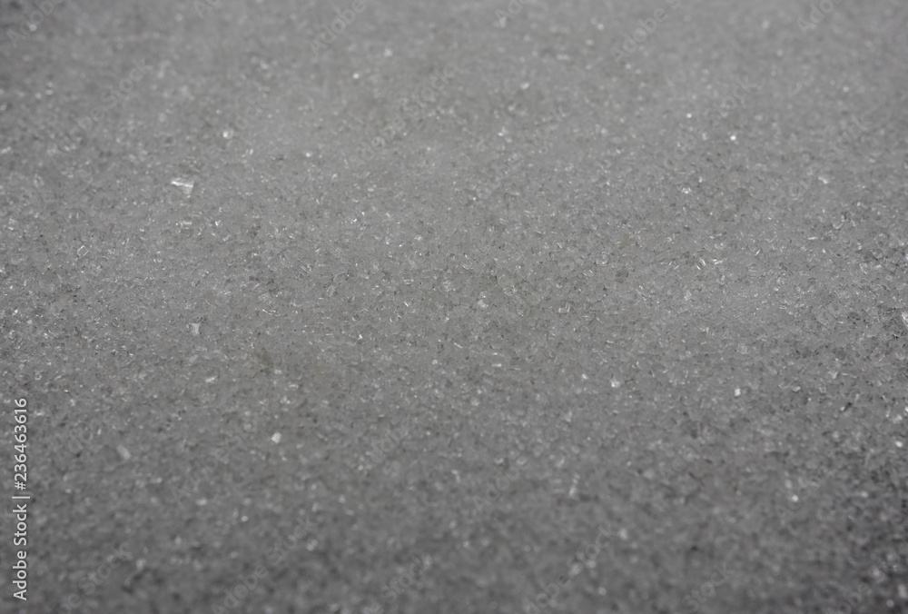 white sugar crystals on a black background