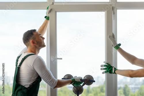 Two workers installing a window photo