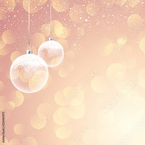 Snowy Christmas baubles on bokeh lights background