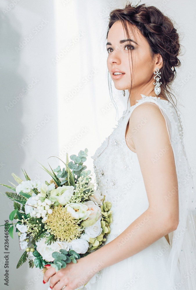 Beautiful brunette bride with stylish make-up in white dress Beautiful brunette bride with stylish make-up in white dress