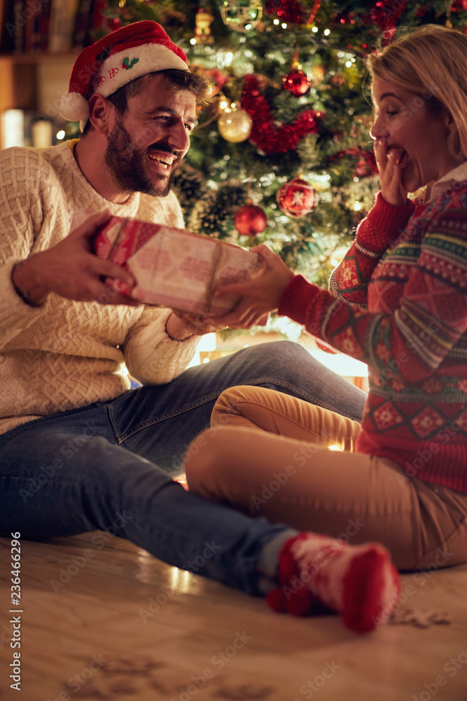 happy young man and woman celebrating Christmas and having fun . happy young man and woman celebrating Christmas and having fun .