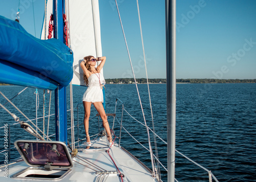 Young sexy woman on her private yacht