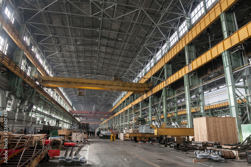 The interior of a big industrial building or factory with steel constructions