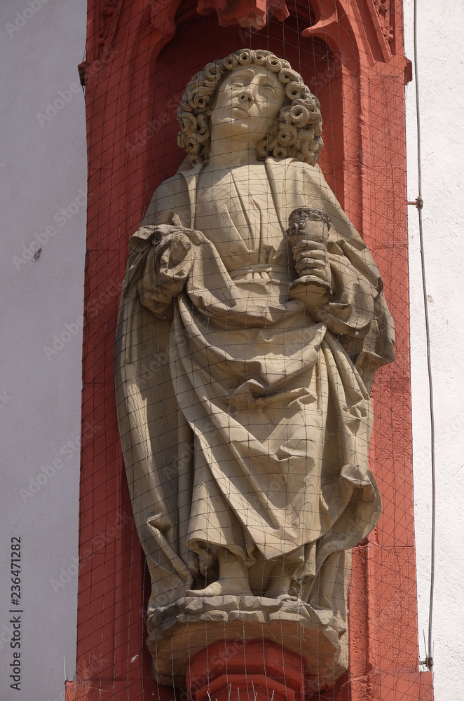 Saint John the Apostle statue on the portal of the Marienkapelle in Wurzburg, Bavaria, Germany