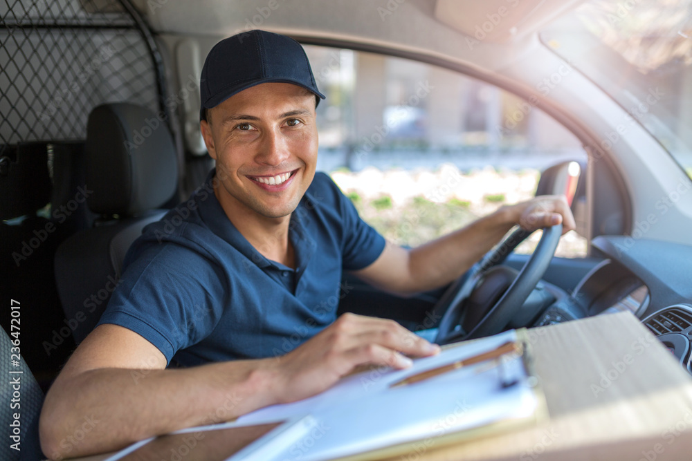 Delivery man sitting in a delivery van Delivery man sitting in a delivery van