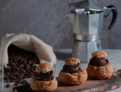 biscuits with chocolate filling.submitted on a wooden board.On the backdrop of a coffee maker, and a mix with coffee