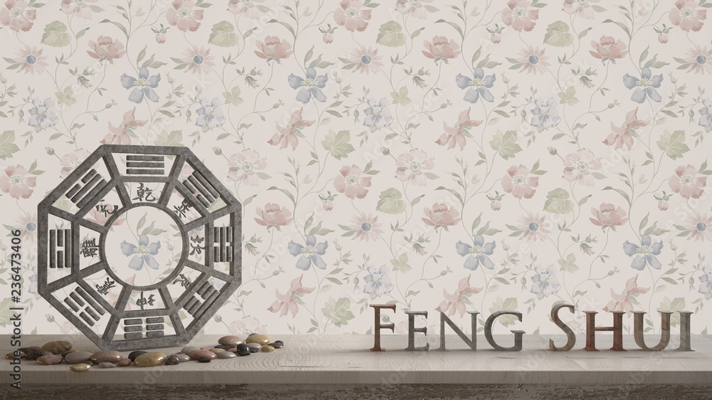 Wooden vintage table shelf with ba gua and 3d letters making the word feng shui with abstract floral background with copy space, zen concept interior design