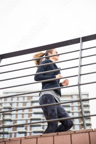 Young woman workout by fence
