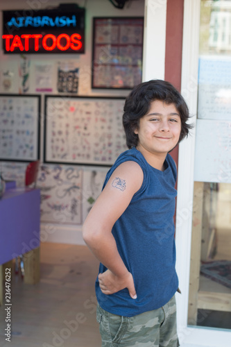 Proud guy of his first tattoo on the door of a local art brush tattoo photo