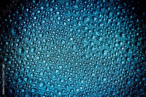 Drops of water on a color background. Blue. Selective focus. Toned.