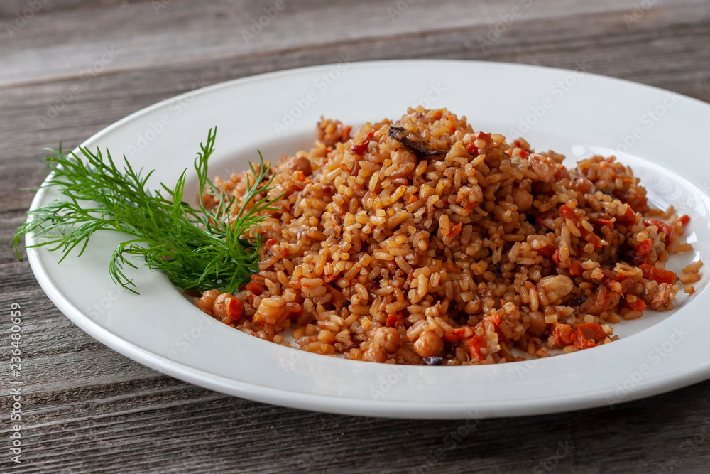 Vegan pilaf with rice, carrots and dried fruits: chickpeas, prunes, dried apricots, raisins. Vegan pilaf with rice, carrots and dried fruits: chickpeas, prunes, dried apricots, raisins.
