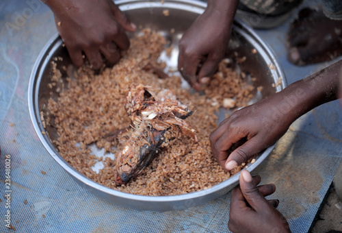 Obraz na płótnie kids eating brown rice and fish in Africa - closeup w salonie