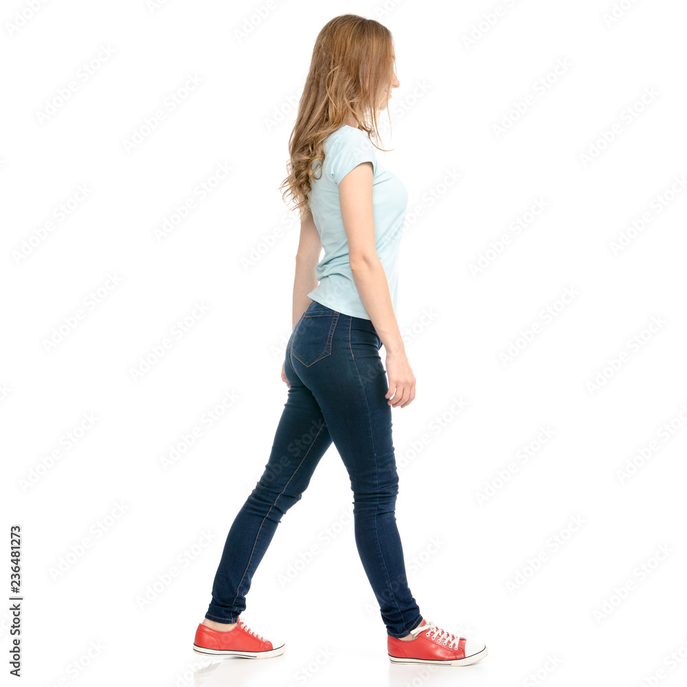 Beautiful woman goes walking on a white background. Isolation Beautiful woman goes walking on a white background. Isolation