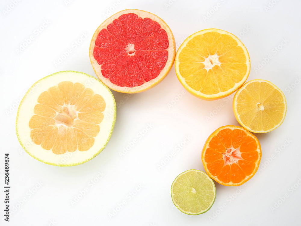 cut pieces of different citrus fruits on white background cut pieces of different citrus fruits on white background