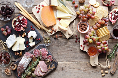 Brunch. Appetizers table with various of cheese, curred meat, sausage, olives, nuts and fruits. Festive family or party snack concept. Overhead view.