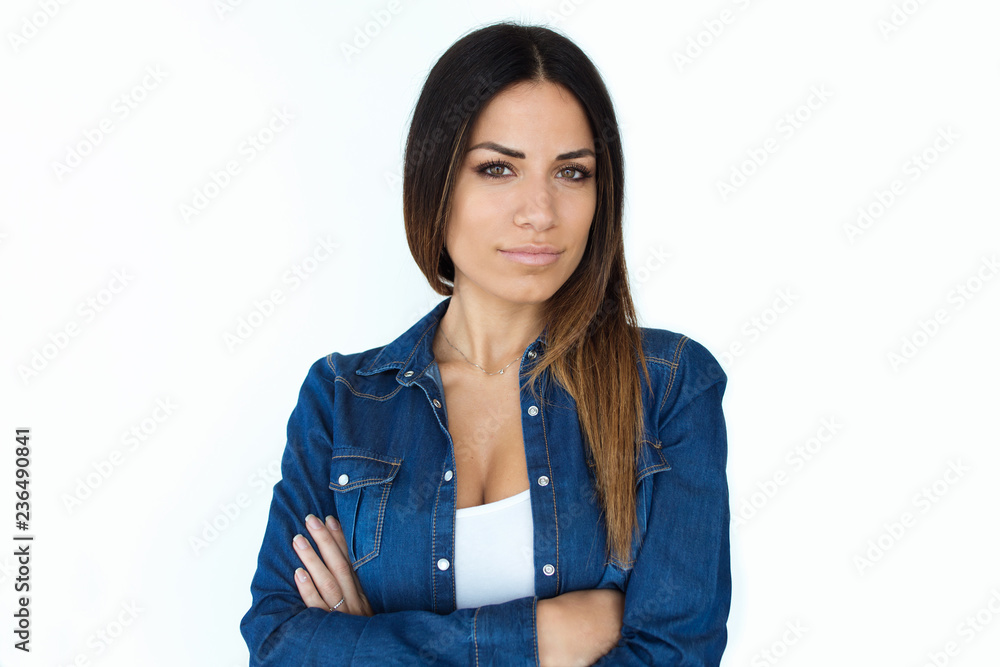 Proud beautiful young woman looking at camera over white backgound. Proud beautiful young woman looking at camera over white backgound.