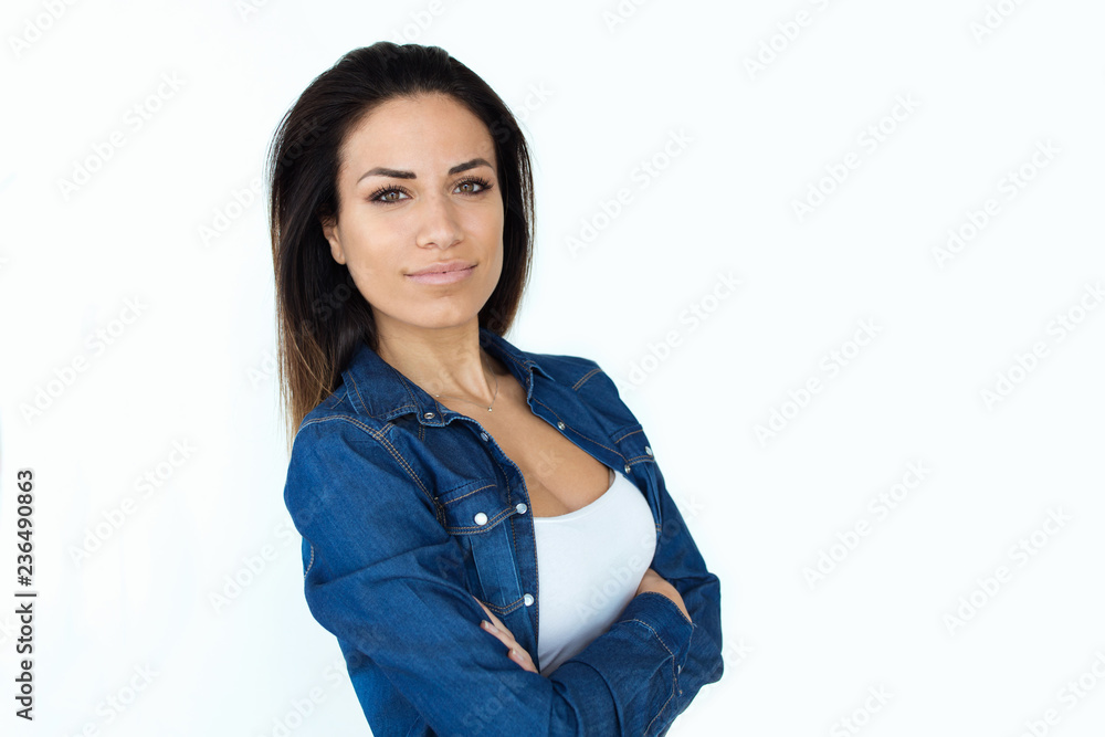Proud beautiful young woman looking at camera over white backgound. Proud beautiful young woman looking at camera over white backgound.