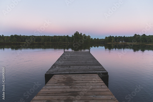 Empty wooden dock at sunset - Muskoka, Ontario, Canada.