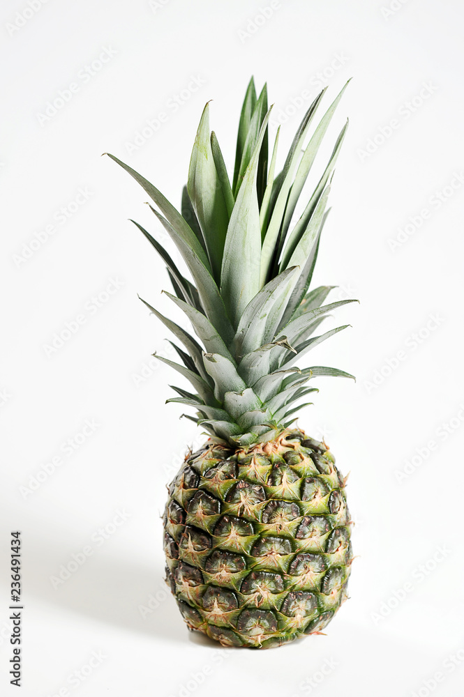 Pineapple on a white background. Close-up. Vertical frame orientation. Pineapple on a white background. Close-up. Vertical frame orientation.