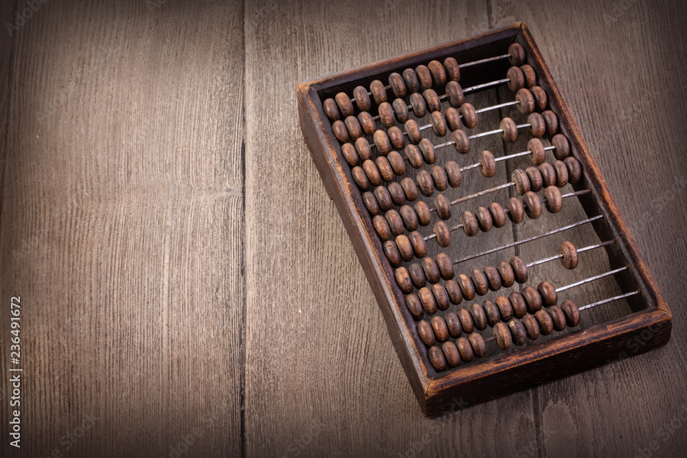 Accounting abacus on wooden textured background Accounting abacus on wooden textured background