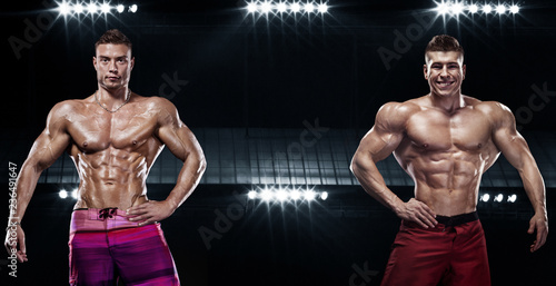 Bodybuilding competitions on the scene. Men and women sportsmens and athletes. Black background with lights.