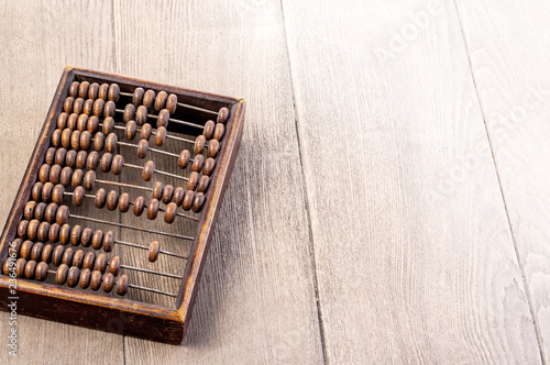 Accounting abacus on wooden textured background
