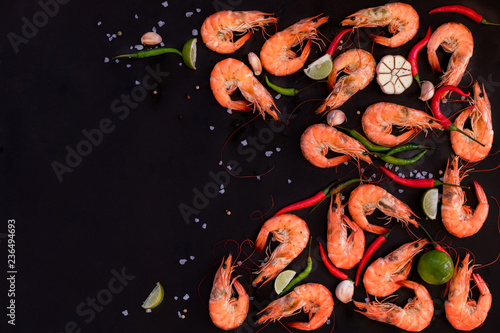 Perfect cooked prawns shrimps with herbs, spices and text space note book top view flat lay layout