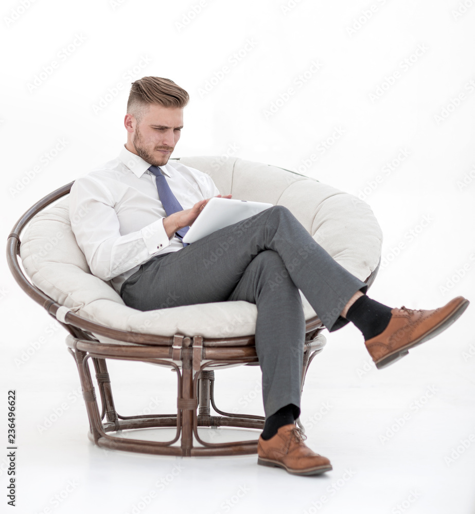 successful businessman using a digital tablet, sitting in a chair successful businessman using a digital tablet, sitting in a chair