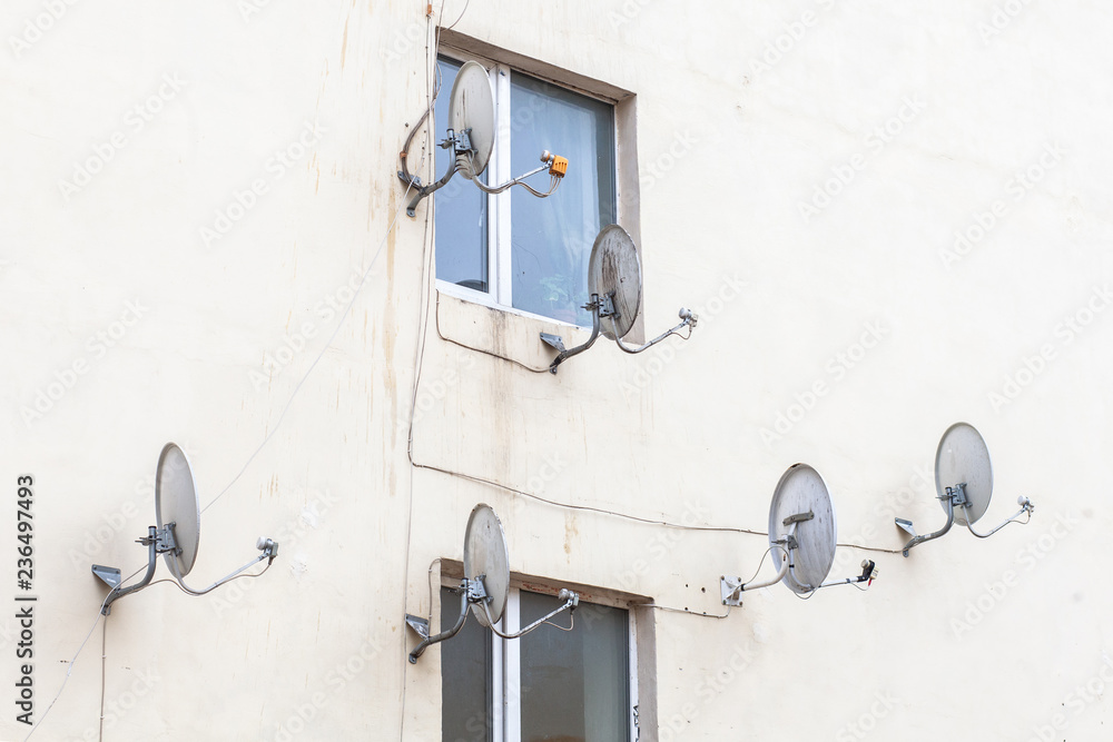 many satellite dishes on facade of house many satellite dishes on facade of house