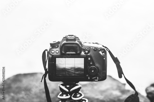 camera set on tripod to take pictures outdoors . stable camera on the beach side