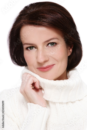 Portrait of attractive smiling mature woman in white pullover